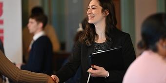 Student shaking hands at a career fair